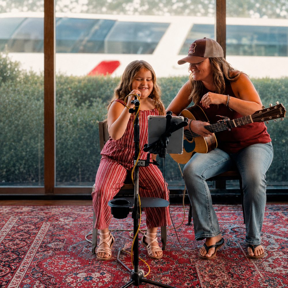 Musician and young performer sharing a moment on stage